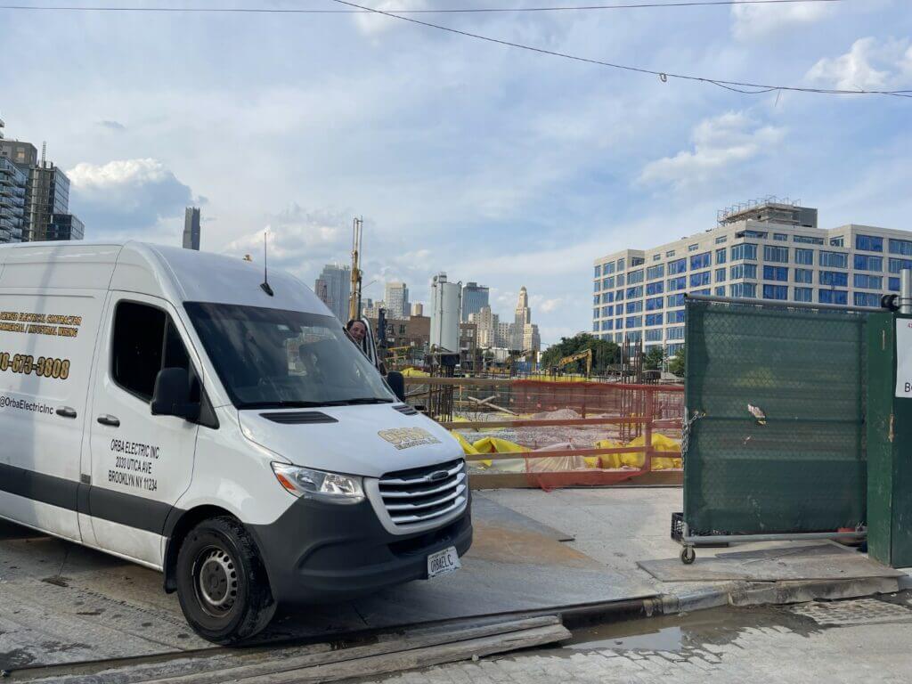 ORBA Electric van parked at a city construction site